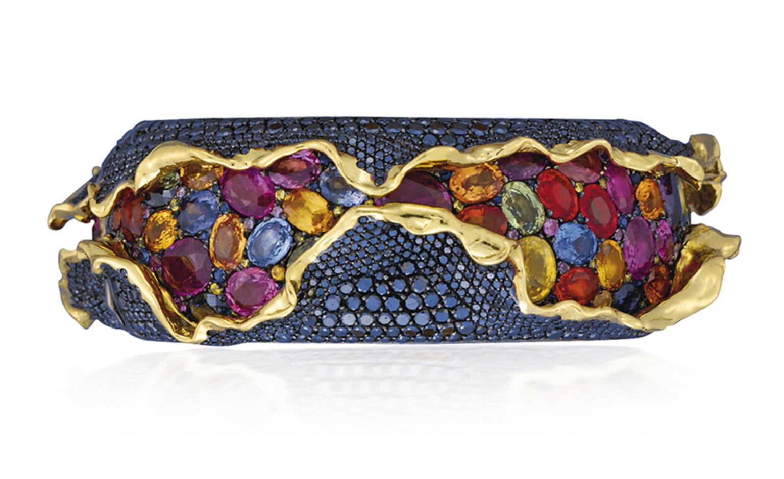 Lot 93 (2). An unusual suite of coloured diamond and coloured sapphire 'Craquele' jewellery, by Andre Marcha. Comprising a hinged bangle, ear clips and a ring. Estimate 50,000 - 60,000 U.S. dollars.