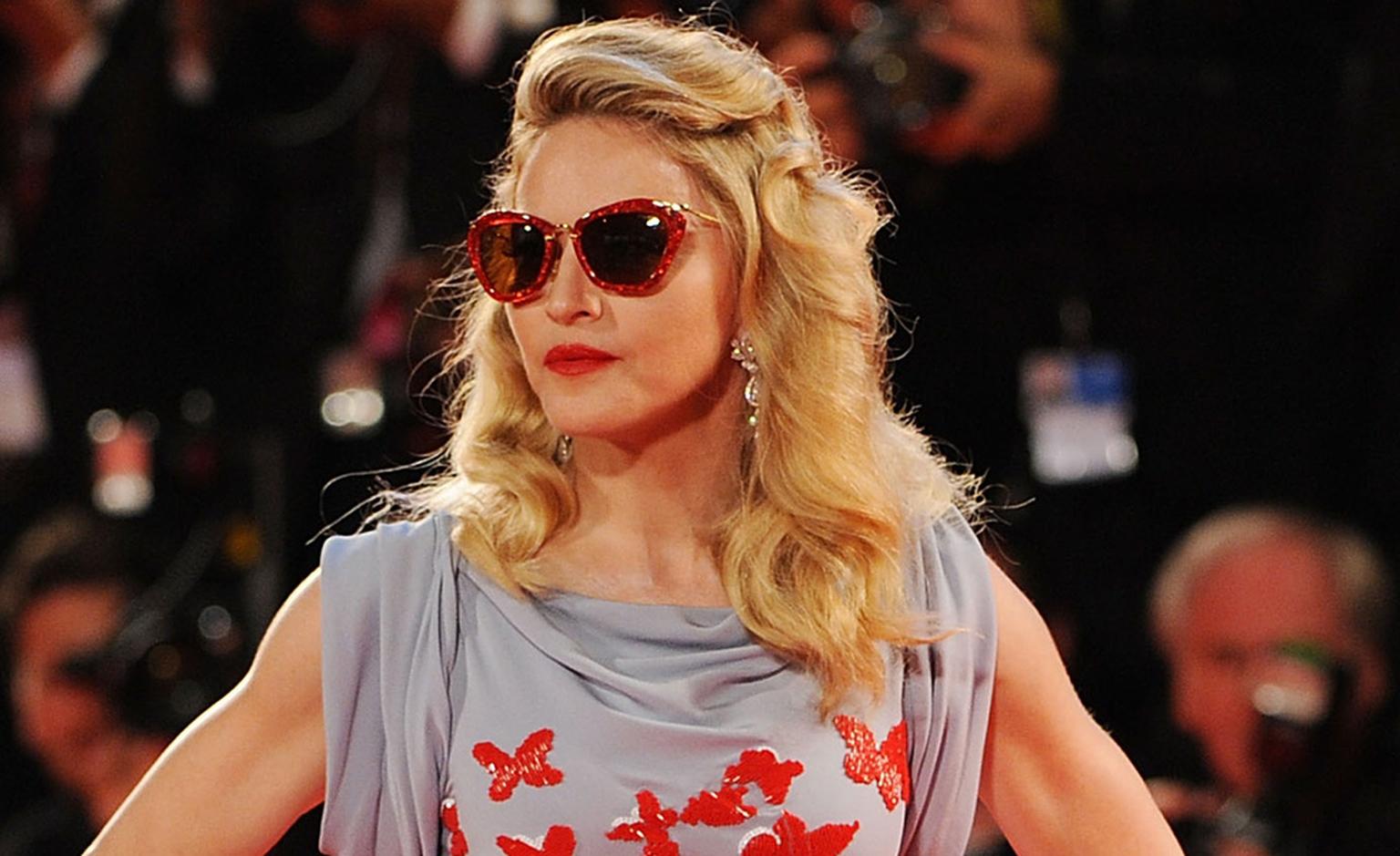 Close up of Madonna at Venice Film Festival 2011 wearing Cartier platinum and diamond pendant earrings